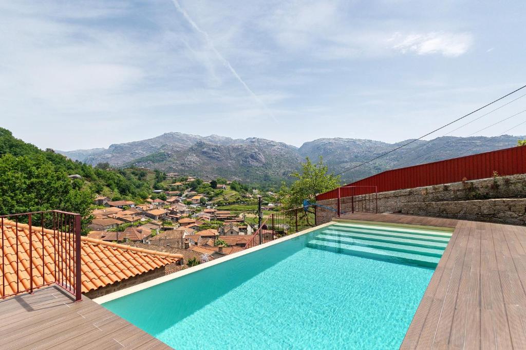 a swimming pool with a view of mountains at Casa Aurora in Campo do Gerês