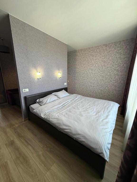 a bed in a bedroom with two pillows on it at Apartment Versailles Park 1 in Irpin