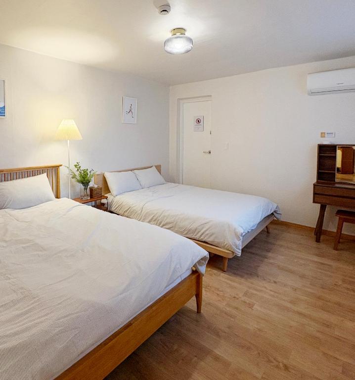 a room with two beds and a piano at Spacious 2BR Apartment near Subway Free Parking Seoul in Seoul