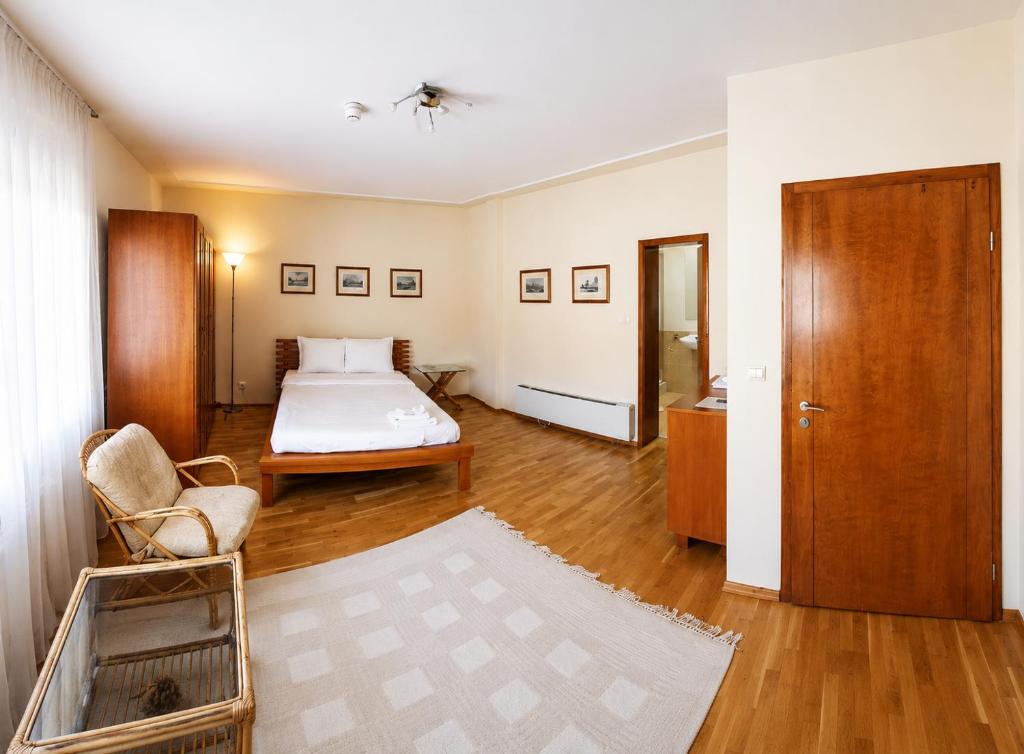 a bedroom with a bed and a chair in it at Room 2 in Gotse Delchev