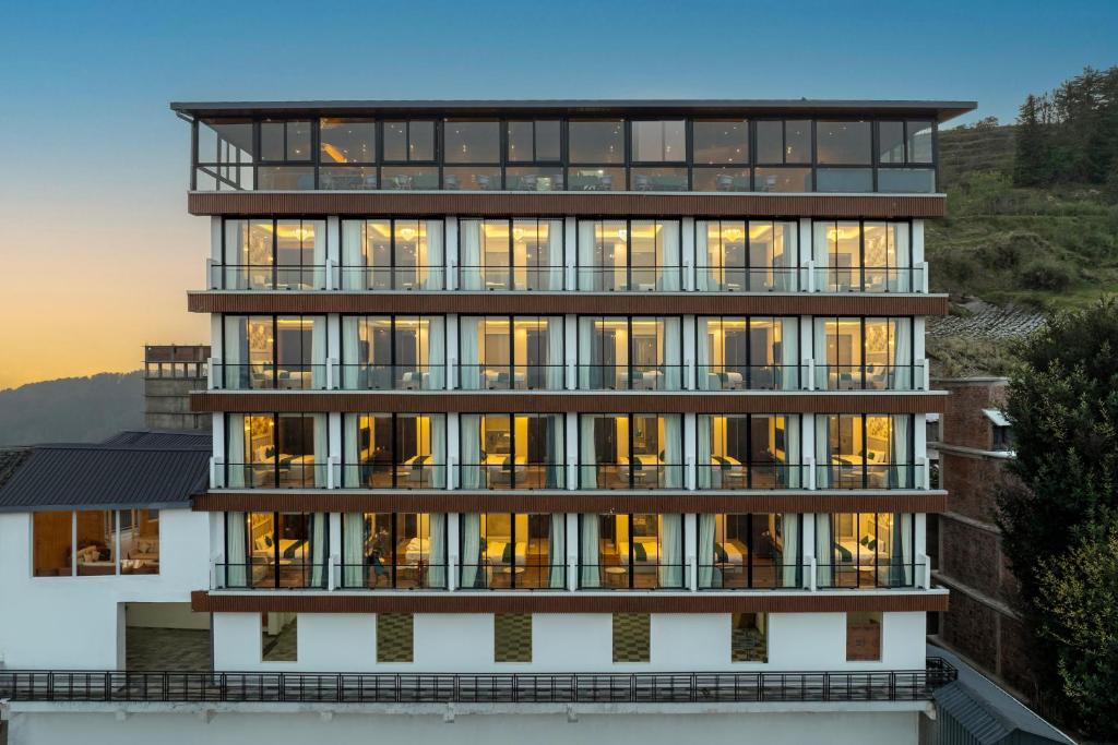 a building with a lot of windows on it at Hotel The Bliss Kufri in Kūfrī