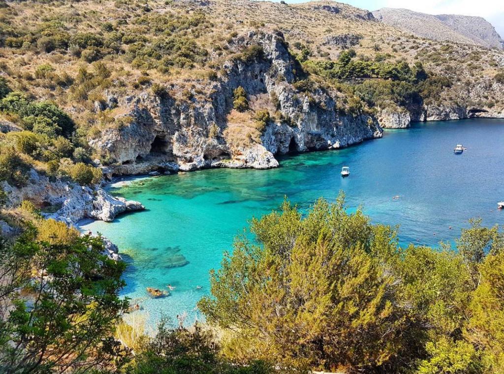 a view of a bay with boats in the water at Domoo Boutique Hotel in Torraca