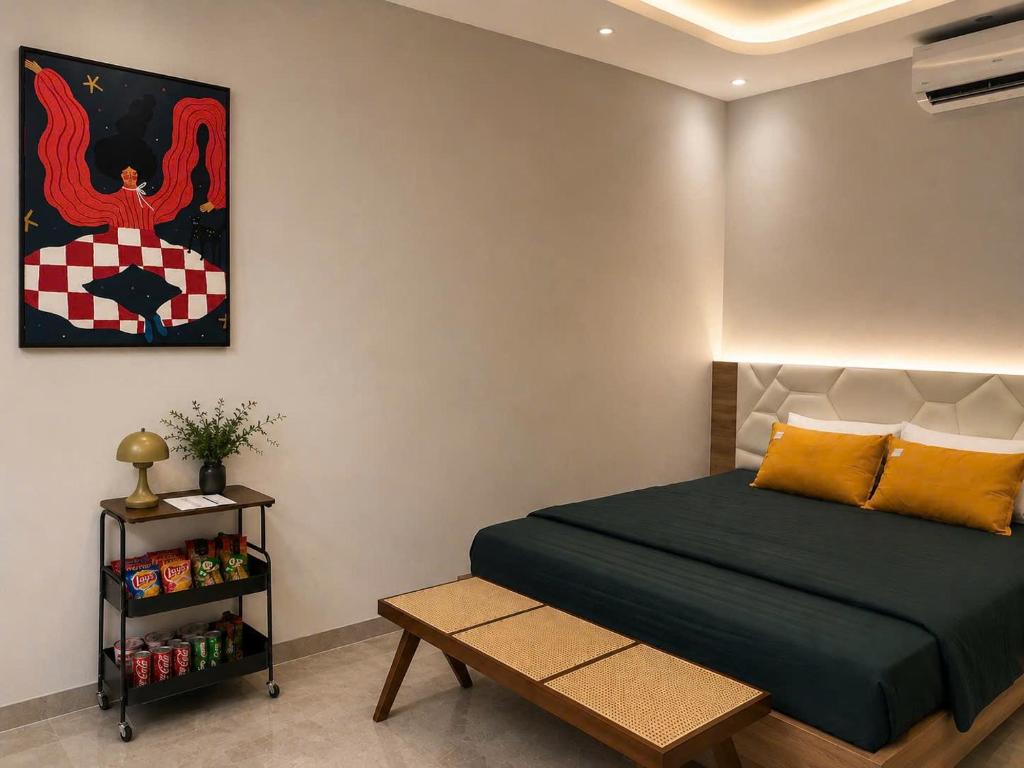 a bedroom with a bed and a painting on the wall at Bi Room in Hai Phong