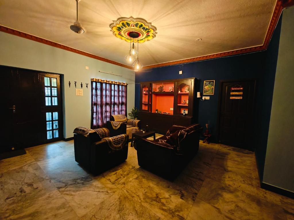 a living room with two couches and a chandelier at Royal Villa Pondy in Pondicherry