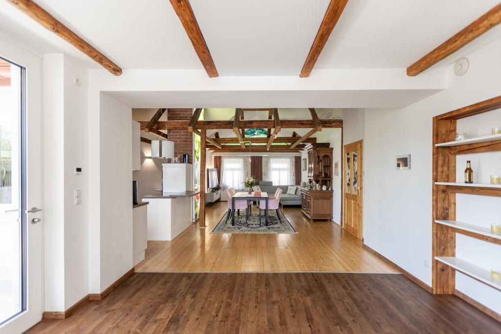 a kitchen and living room with white walls and wooden ceilings at DACHJUWEL Luxus - Apartment Penthouse Ferienwohnung in Leibnitz