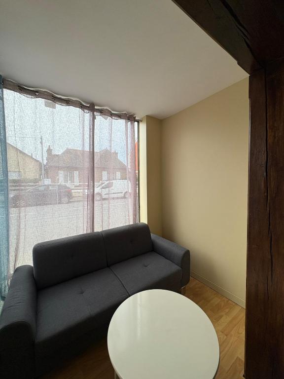 a living room with a couch and a table at Douglas in Saint Malo