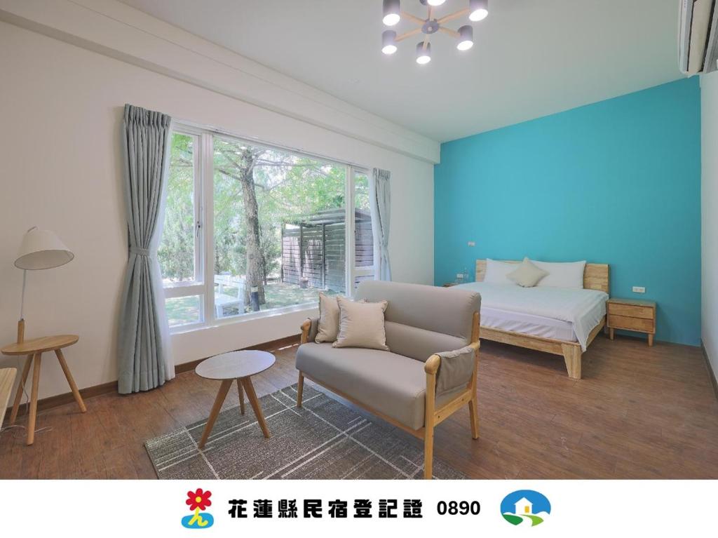 a living room with a couch and a bed and a window at OwlStay Green Villa in Pinghe