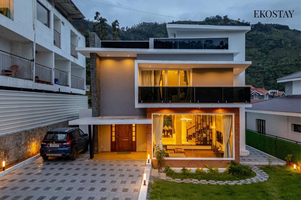 a house with a car parked in front of it at EKOSTAY - Amber Villa in Kodaikānāl