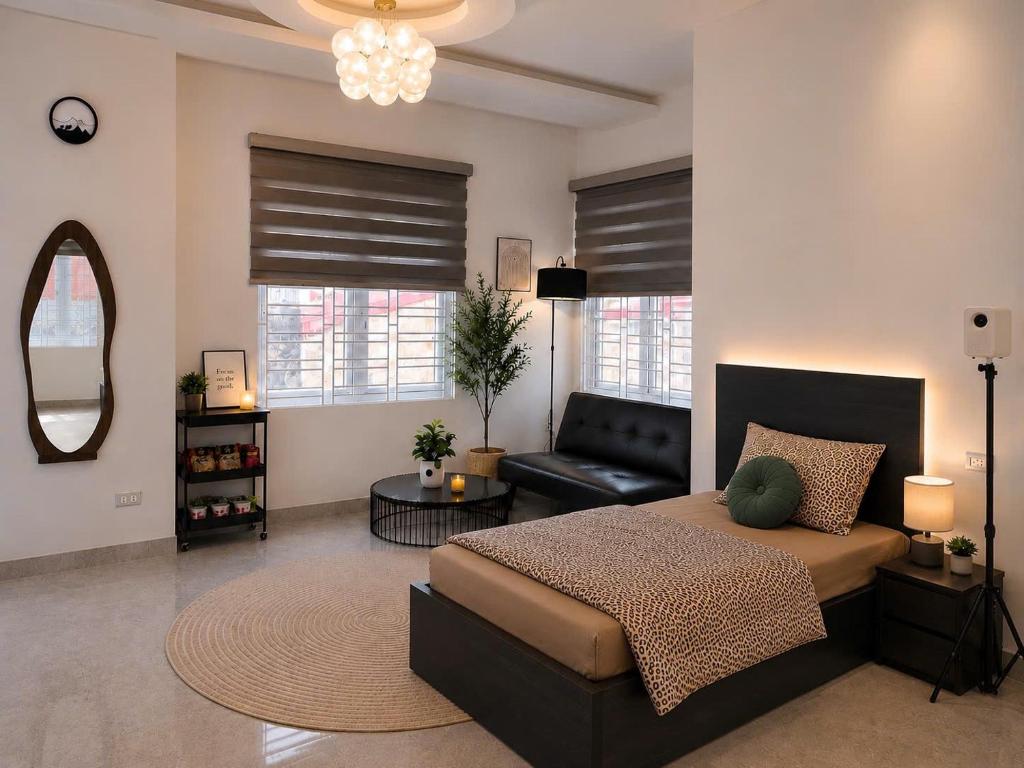 a bedroom with a large bed and a couch at Moon Room in Hai Phong