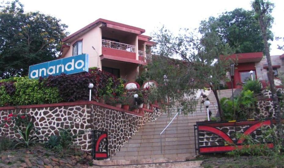 a house with a sign that says amoco on it at Hotel Anando , Saputara in Saputara