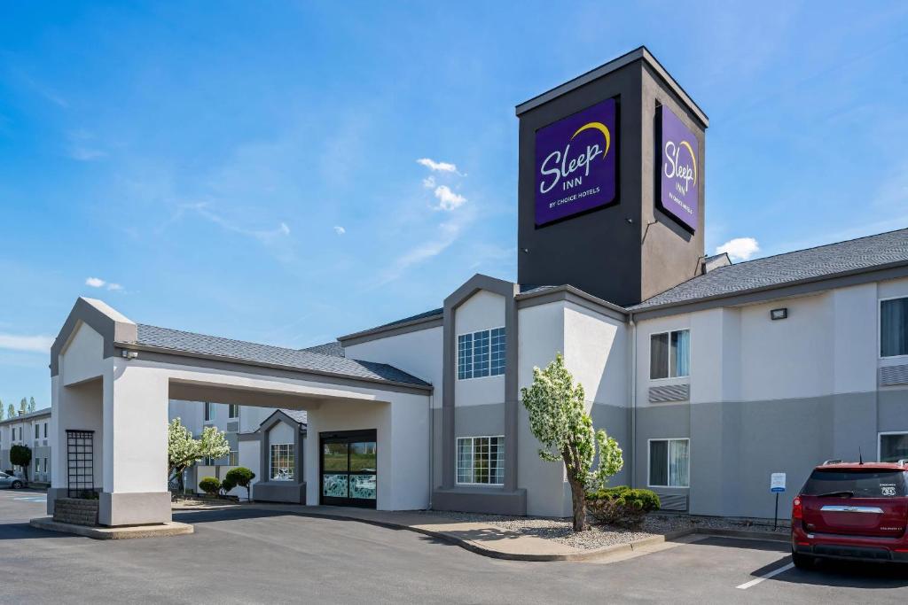 a hotel with a sign on the side of a building at Sleep Inn near Washington State Line in Post Falls