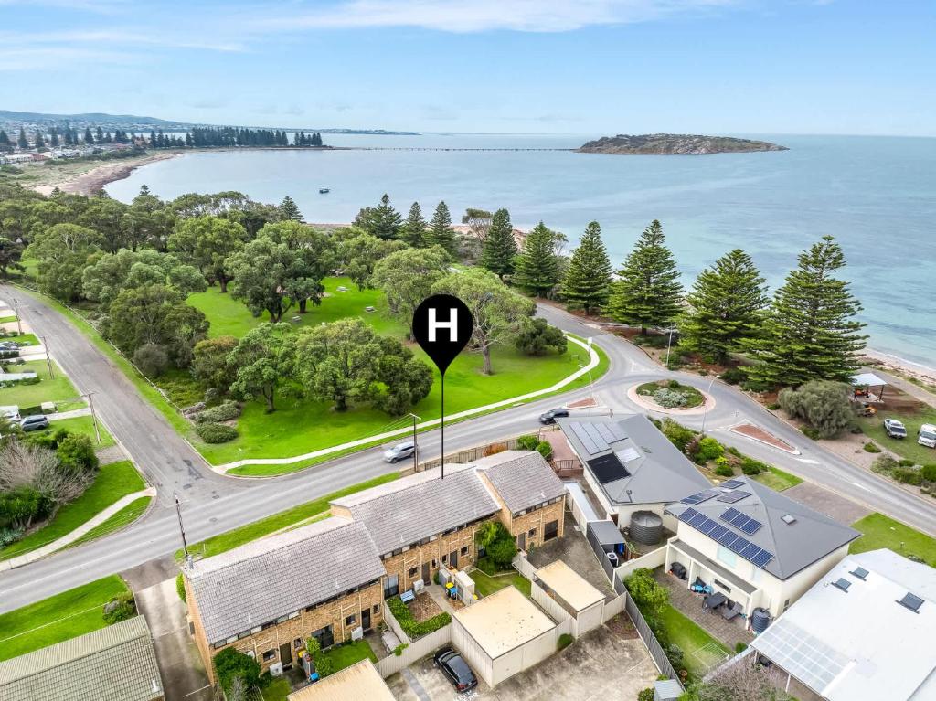 an aerial view of a house with a sign that says h at 4 1 Harbour View Terrace BYO Linen in Victor Harbor