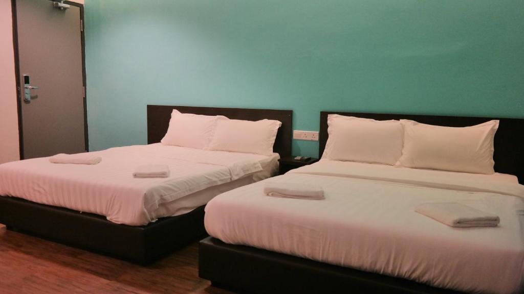 Postel nebo postele na pokoji v ubytování Clover Hotel Ipoh