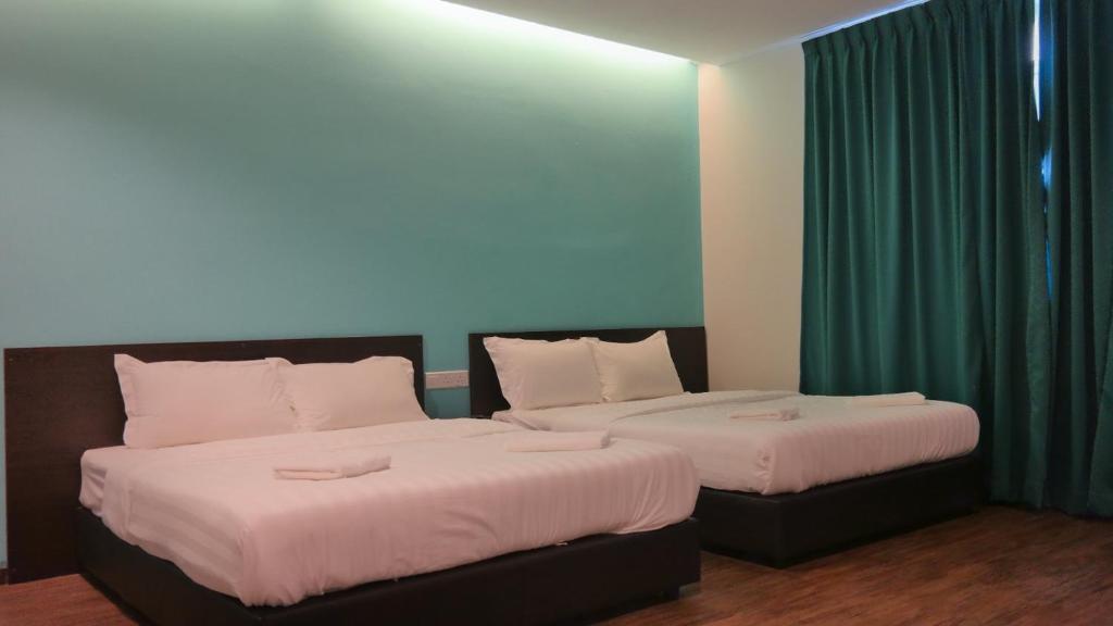 Postel nebo postele na pokoji v ubytování Clover Hotel Ipoh