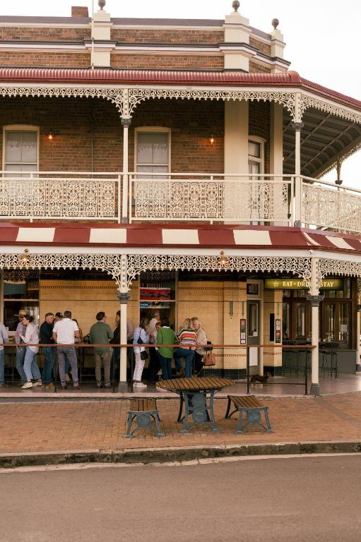 a group of people standing outside of a building at The Bolt Inn in Uralla