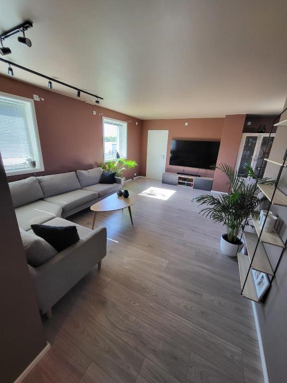 a living room with a couch and a flat screen tv at Local home apartment in Stavanger in Stavanger