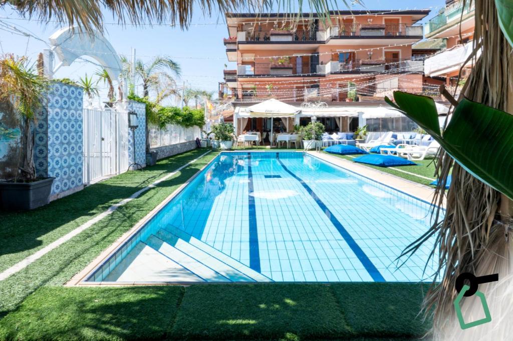 a swimming pool in the backyard of a building at Hotiday Taormina Mazzeo in Taormina