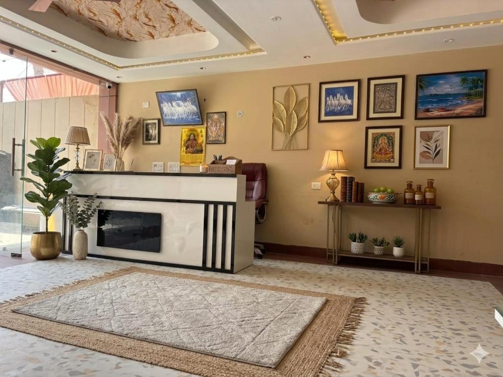 a living room with a fireplace and a couch at Hotel Green Land in Mathura