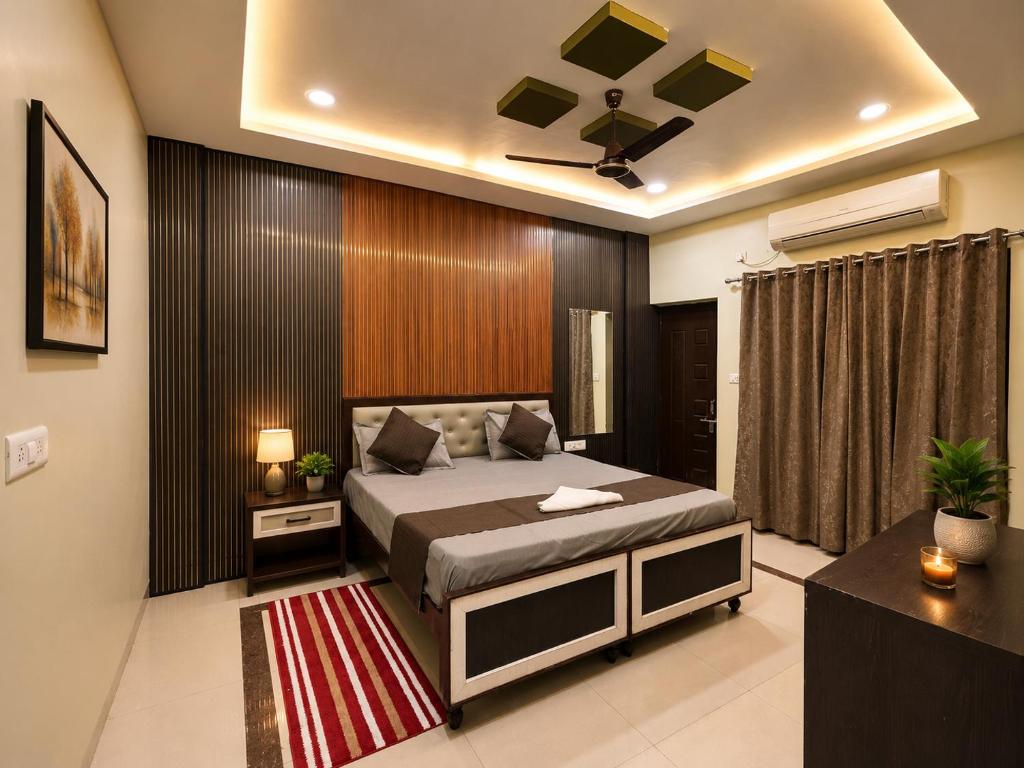 a bedroom with a bed and a ceiling fan at Hotel Balaji Inn in Raipur