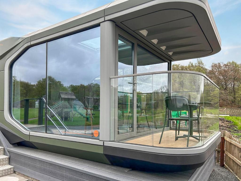 a screened in porch with a chair sitting on a deck at Vessel 1 - Ukc9441 in Glasgow