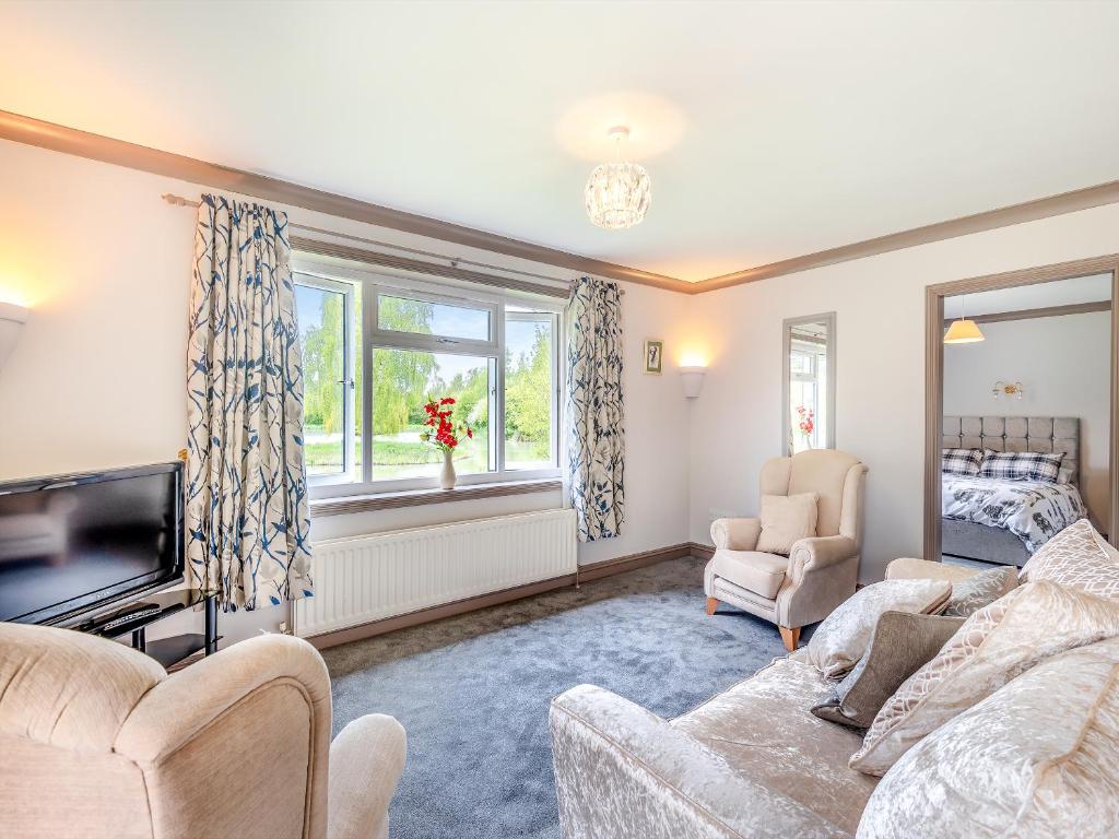 a living room with two couches and a tv at Swallow - Uk41035 in Marston