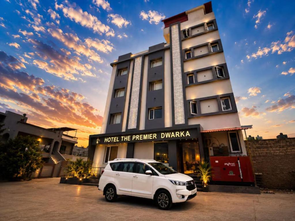 a white car parked in front of a building at The Premier, Dwarka in Dwarka
