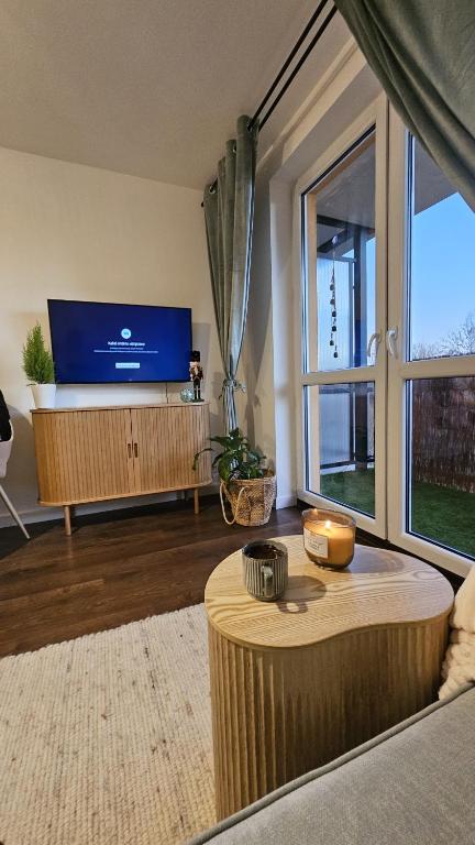 a living room with a large tv and a large window at Boho in Zamość