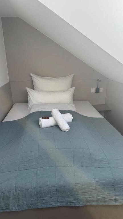 a bed with two towels on top of it at Hotel Falken in Hechingen