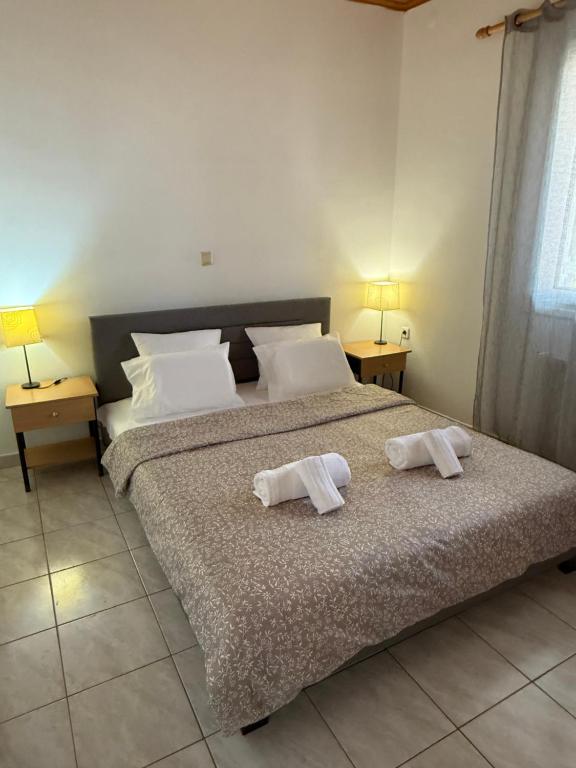 a bedroom with a bed with two towels on it at Lemon tree apartment in Kyllini
