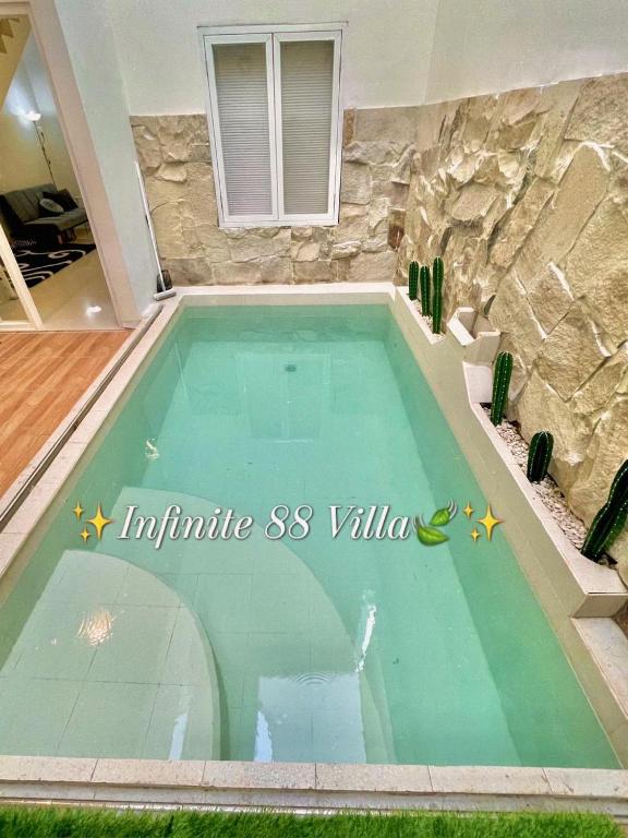 a swimming pool in the middle of a house at infinite 88 villa in Batu