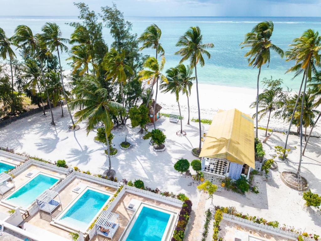 an aerial view of a resort with palm trees and the ocean at ZAN Orient Bwejuu Hotel in Makunduchi