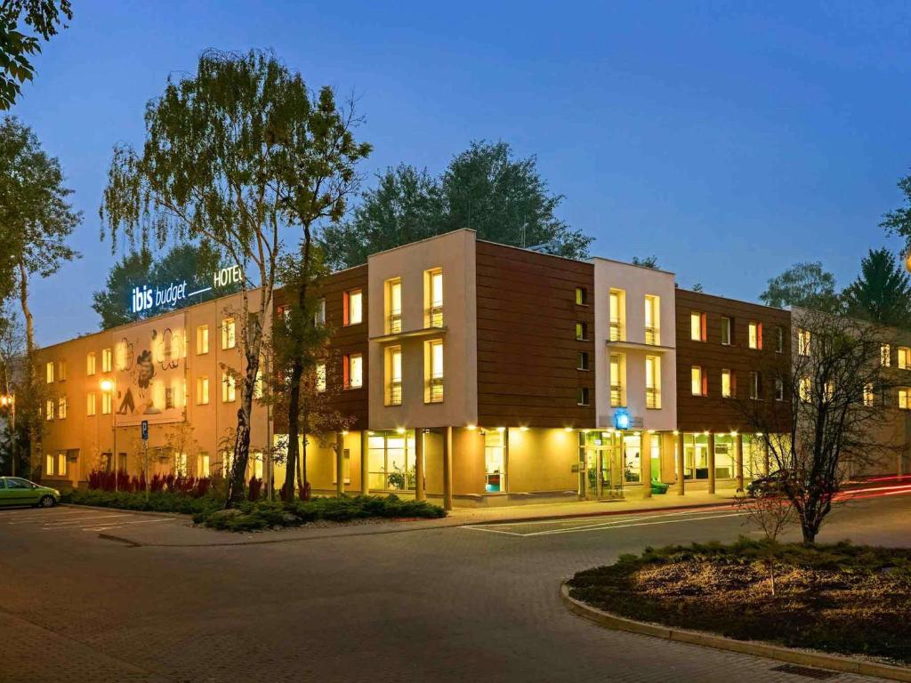 a building with lights on in a street at ibis budget Wrocław Stadion in Wrocław