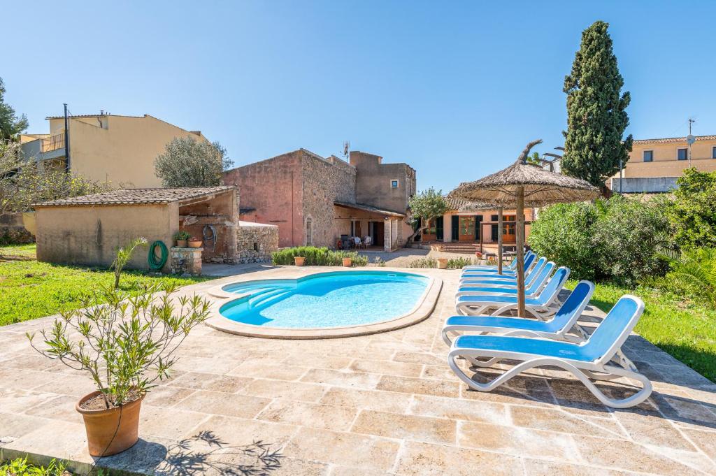 a group of chairs sitting next to a swimming pool at Casa Can Pauma in Caʼs Concos