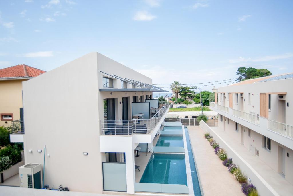 a view of the pool from the balcony of a building at Evaeri Suites in Mytikas