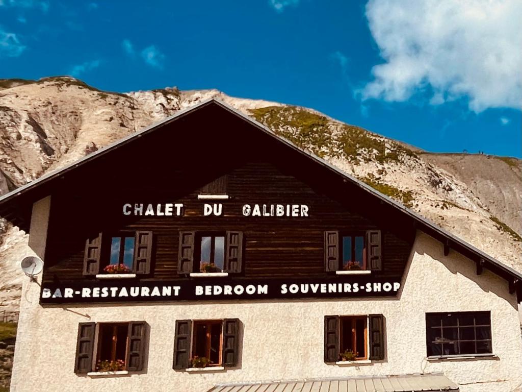 a building in front of a mountain at Beau Refuge du Galibier in Le Monêtier-les-Bains