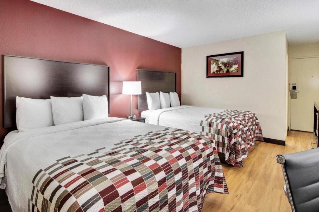 a hotel room with two beds and a red wall at Boardman in McKays Corners