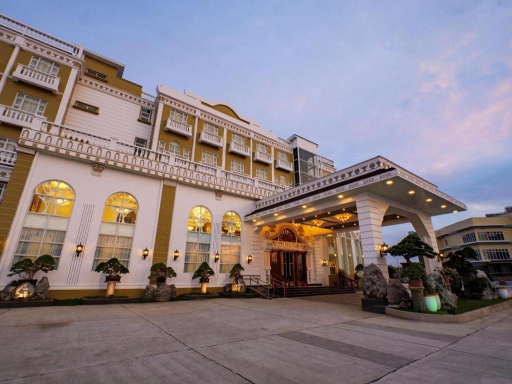 a large white building with a courtyard in front of it at HOTEL VAN GOGH in Candon