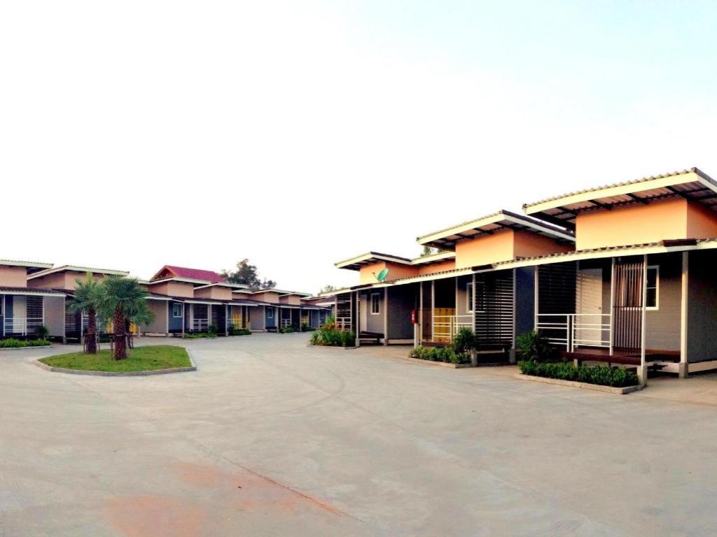a row of houses in a parking lot at Zigzag Resort in Yasothon