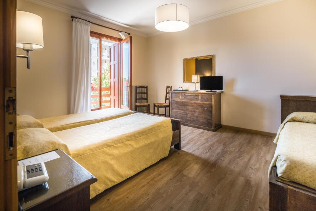 Postel nebo postele na pokoji v ubytování Hotel Capanna d'Oro