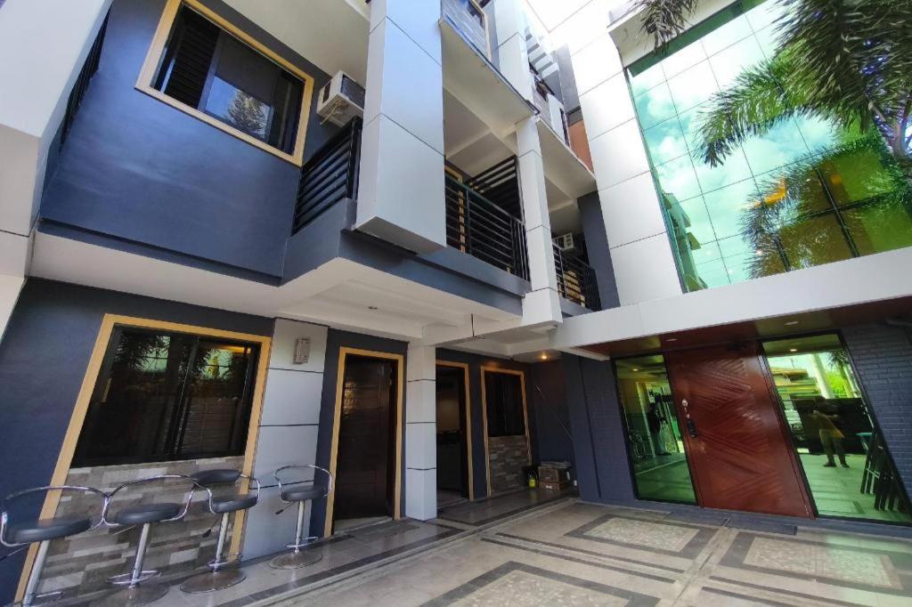 a facade of a building with doors and windows at Ecoland 88 Apartelle and Suite near SM Davao in Davao City