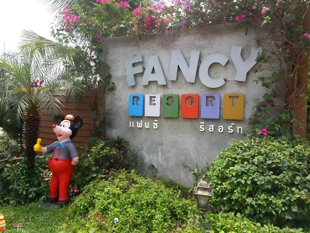 a sign for the entrance to a disney resort at Fancy Resort in Ban Samran