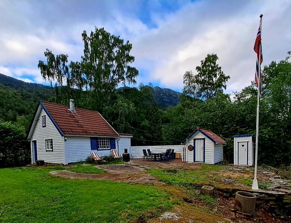 a house with a flag in front of it at The Old Cabin in Vikedal