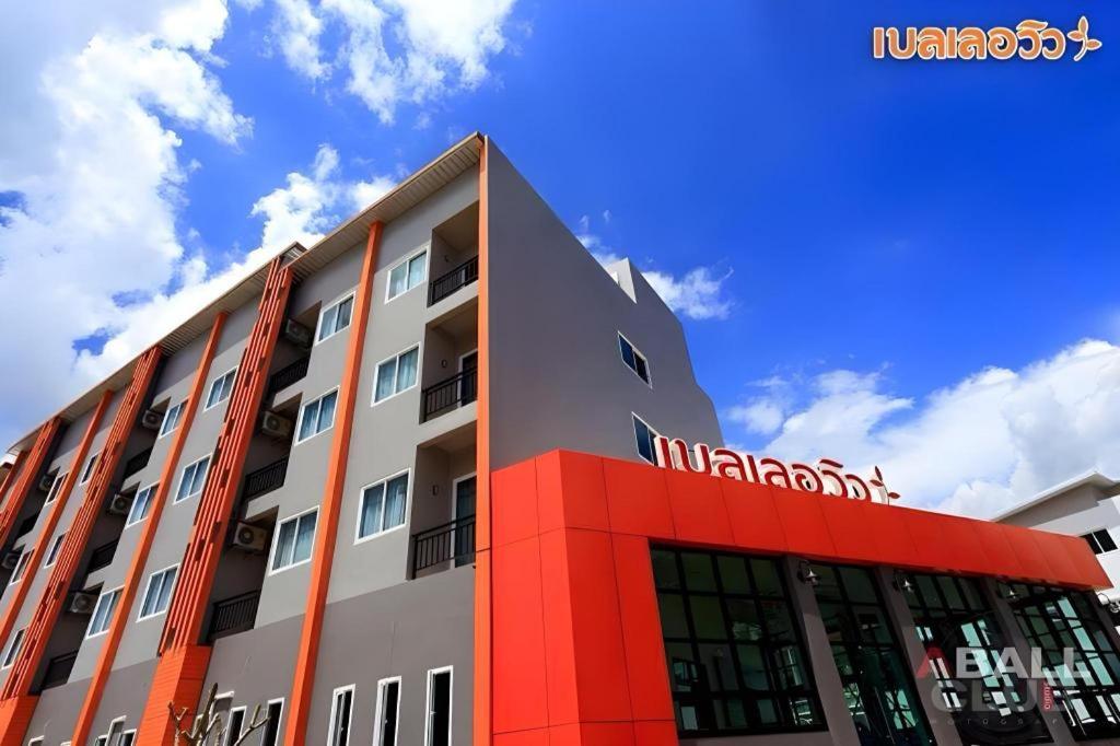 a building with a nissan sign on top of it at Belleville hotel in Phetchabun