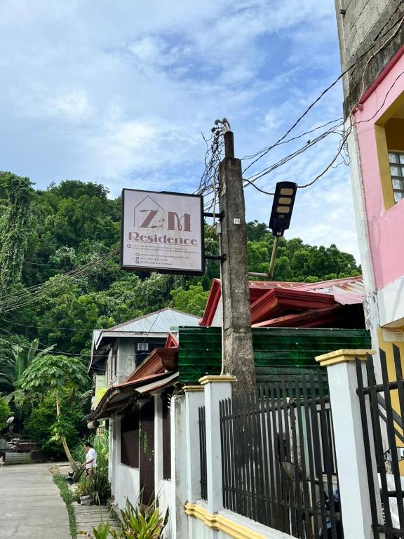 a sign for a z inn restaurant on a building at ZM Residence in Dapa