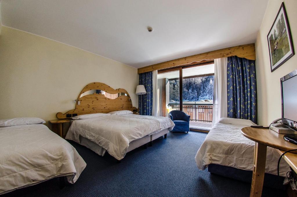 Postel nebo postele na pokoji v ubytování Hotel Rivè - Complesso Turistico Campo Smith