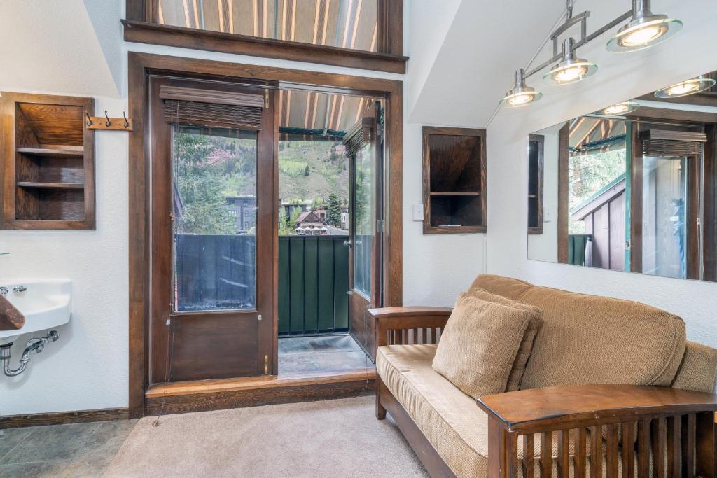 a living room with a couch and a sink at Manitou Lodge 11 by Alpine Lodging Telluride in Telluride