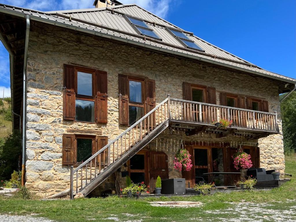 an old stone house with a staircase on it at Le Cerf de la Lune in Crots