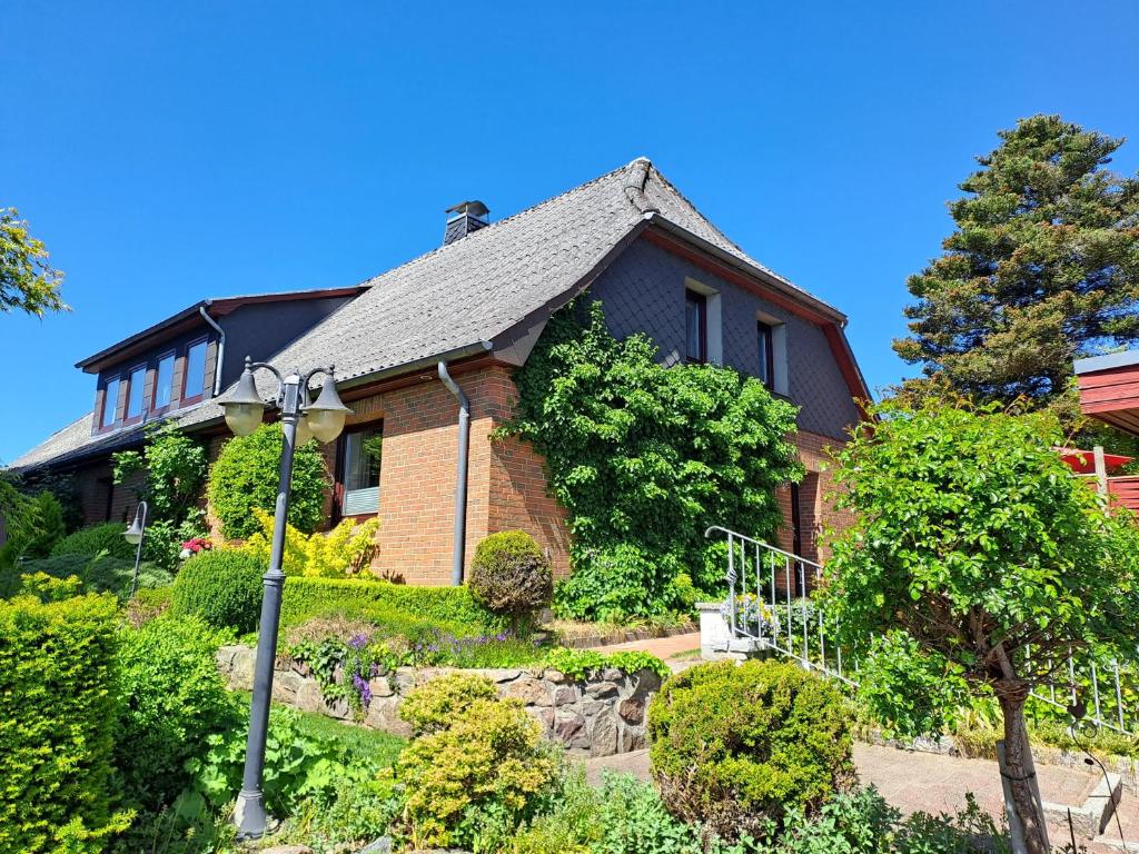 a brick house with a black roof at Ferienwohnung Rahn in Freienwill
