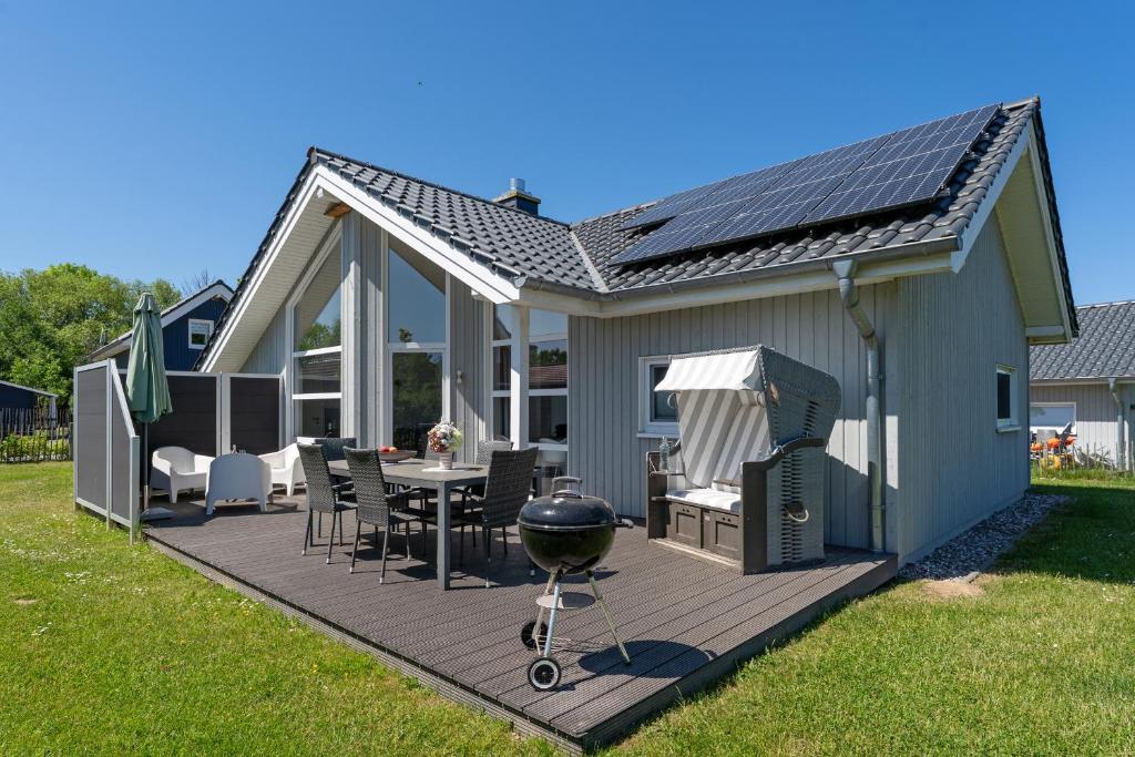 a backyard deck with a grill and a barbecue at Nordstern in Schönberger Strand