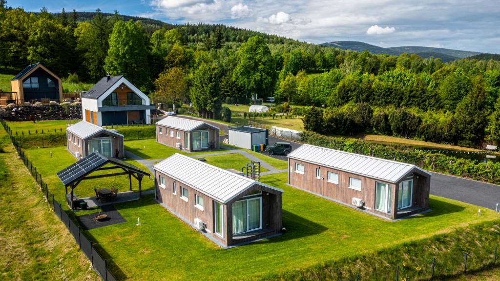 an overhead view of a group of tiny houses on a grass field at Domki Izerskie in Krobica